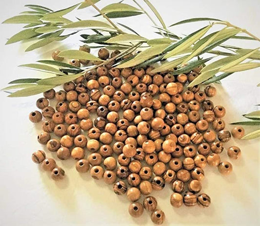12 mm Round Olive Wood Beads From Bethlehem On Table With Olive Branch .